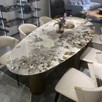 Oval marble dining table with white top and three gold steel legs main product image