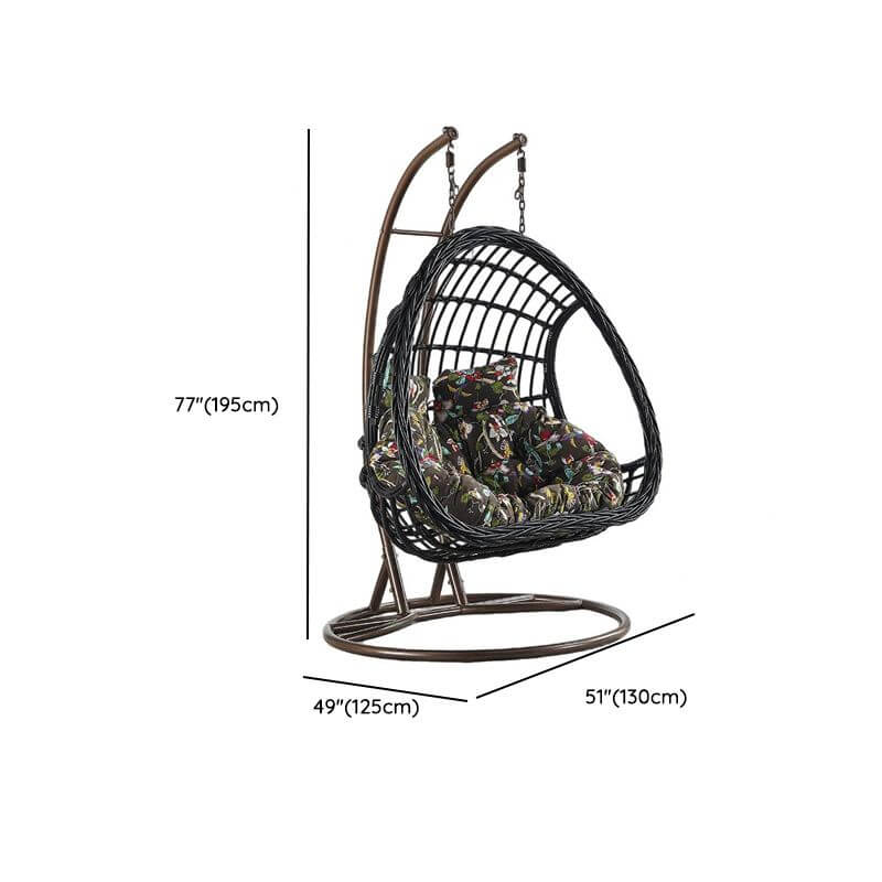 Tropical upholstered porch swing with metal chain and included stand for outdoor relaxation