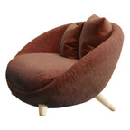 Scandinavian papasan chair with fixed back, sloped arms, cotton blend fabric, and 2 pillows