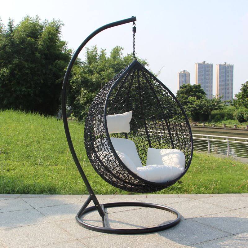 Metal porch swing with stand, cushions, and chain for comfortable outdoor seating