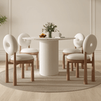 Round terrazzo dining table with soft wool upholstered chairs for a trendy home setup