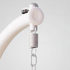 Pink metal 2-seater porch swing with stand, chain, and cushions for outdoor seating