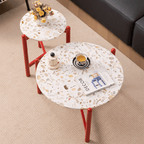 Round side table with vibrant red terrazzo top, featuring a modern minimalist design