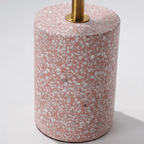 Pink terrazzo coffee table with gold accents in a modern minimalist design