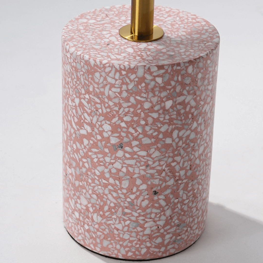 Pink terrazzo coffee table with gold accents in a modern minimalist design