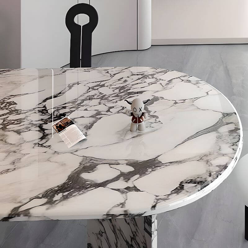 Oval dining table with white marble top and fixed base, perfect for contemporary dining rooms