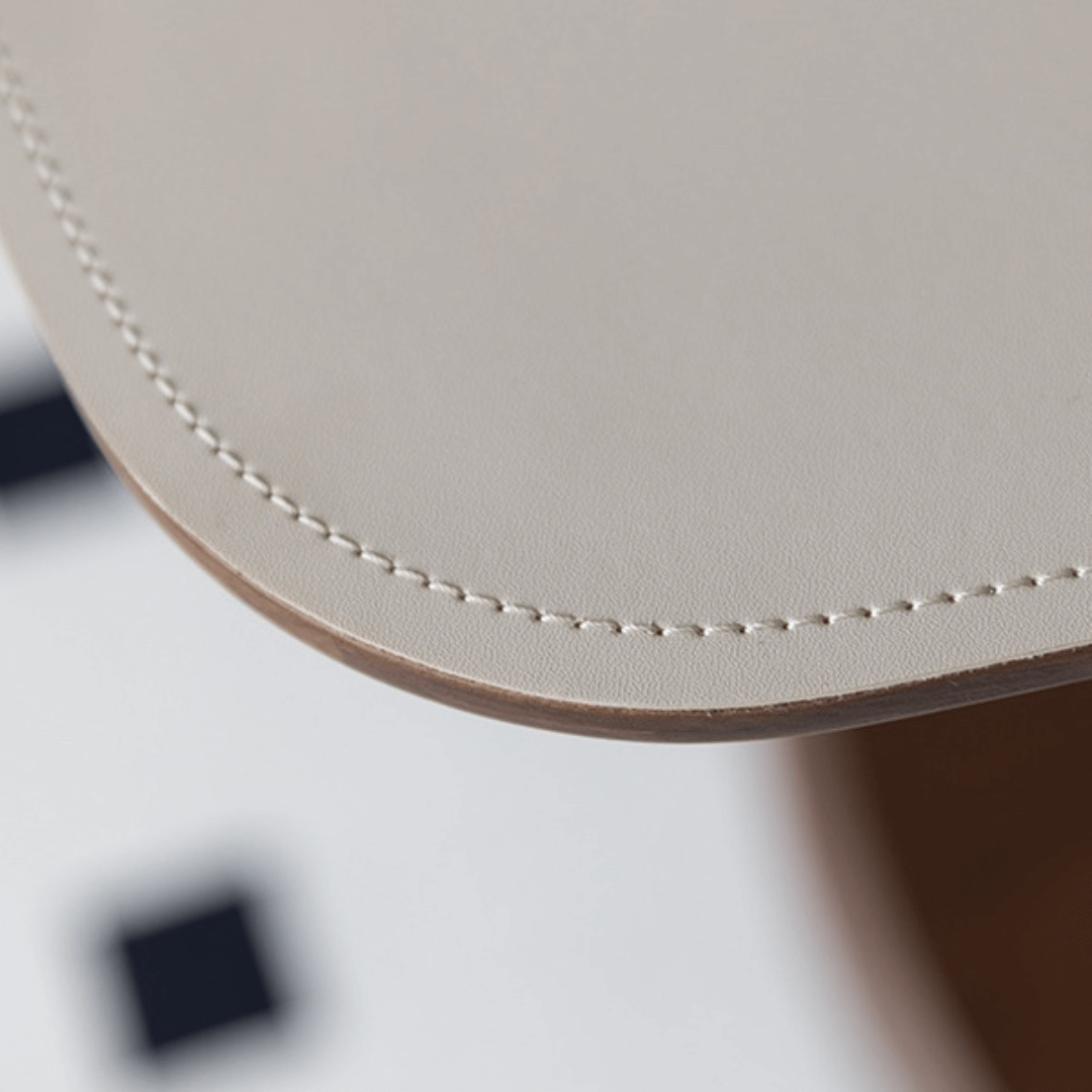 Movable end table in classic beige saddle leather, perfect for cozy living spaces