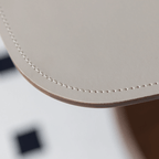 Movable end table in classic beige saddle leather, perfect for cozy living spaces