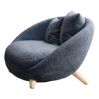 Scandinavian papasan chair with fixed back, sloped arms, cotton blend fabric, and 2 pillows