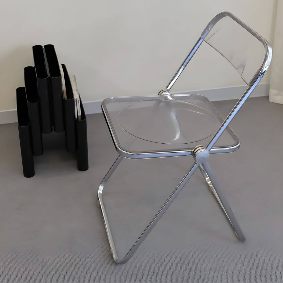 Contemporary acrylic folding armless chair with open back, ideal for dining rooms