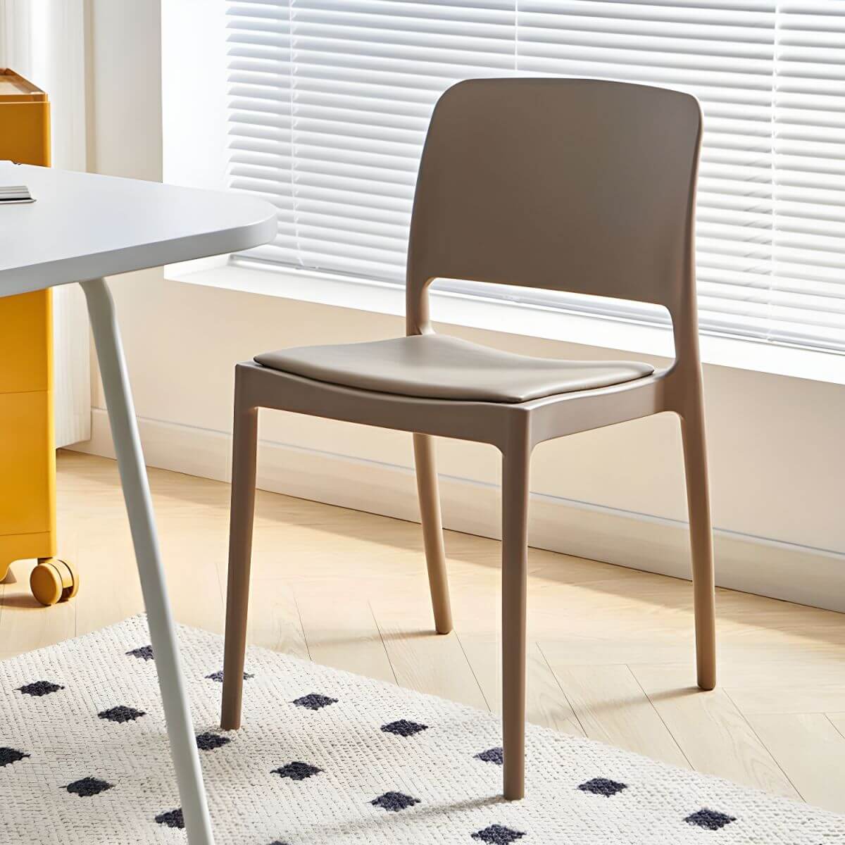 Scandinavian plastic and acrylic dining chair with low backrest and armless design