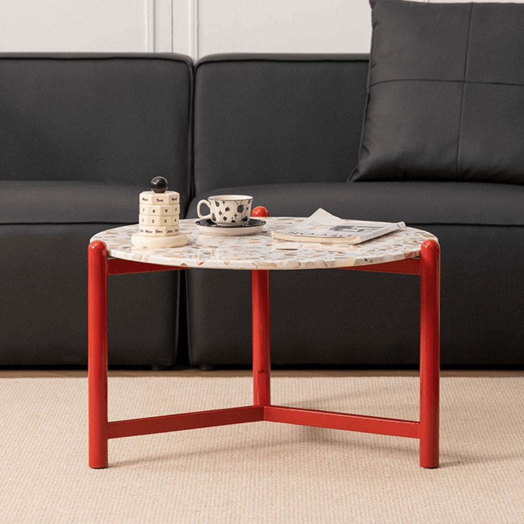 Round side table with vibrant red terrazzo top, featuring a modern minimalist design