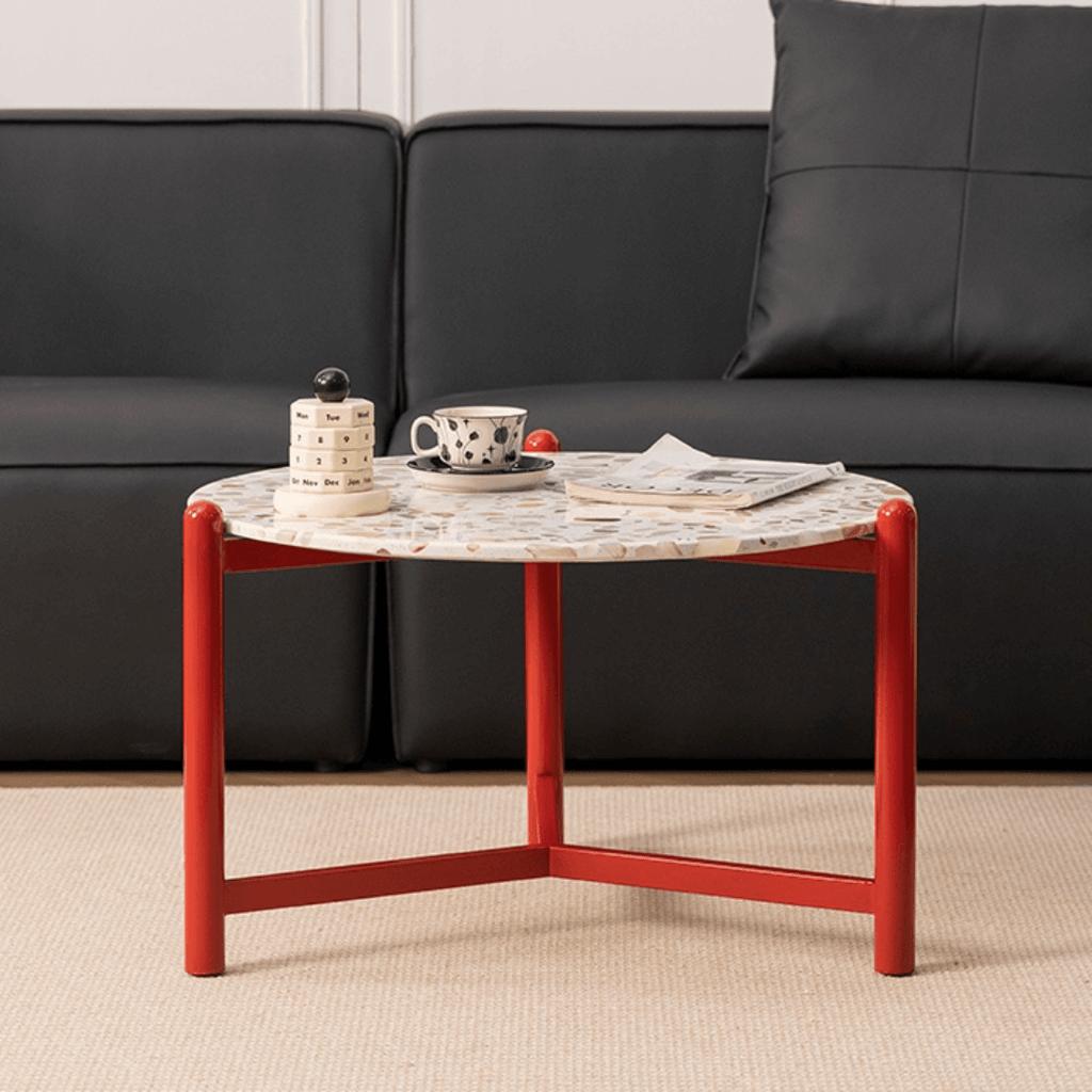 Round side table with vibrant red terrazzo top, featuring a modern minimalist design