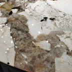 Oval marble dining table with white top and three gold steel legs