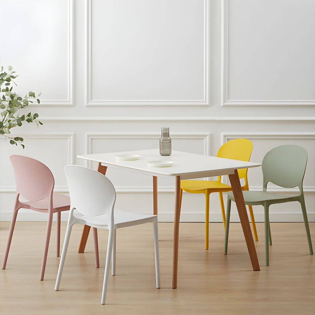Scandinavian plastic dining chair with open back and four legs, ideal for home use