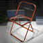 Contemporary acrylic folding armless chair with open back, ideal for dining rooms