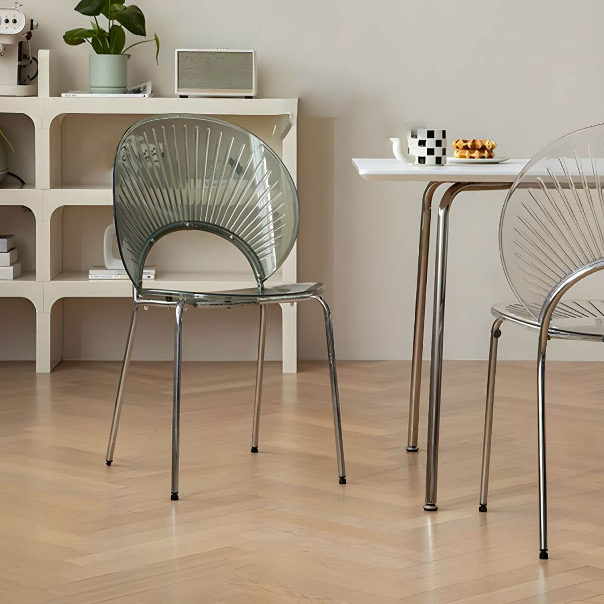 Stackable Scandinavian style dining chair with plastic seat, acrylic back, and silver legs main product image