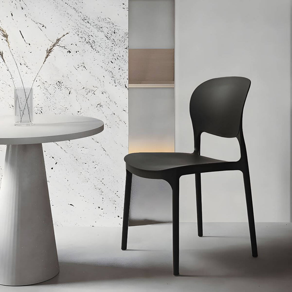 Stackable modern side chair with low back made of plastic and acrylic, perfect for contemporary dining