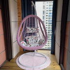 Tropical upholstered porch swing with metal chain and included stand for outdoor relaxation