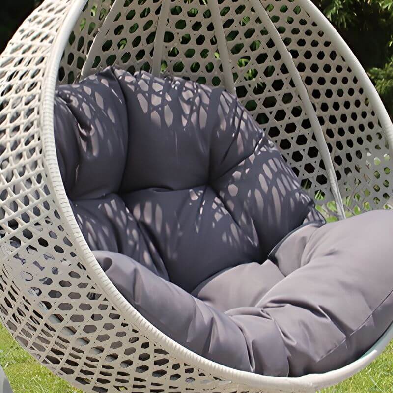 Metal porch swing with stand, cushions, and chain for comfortable outdoor seating