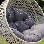 Metal porch swing with stand, cushions, and chain for comfortable outdoor seating