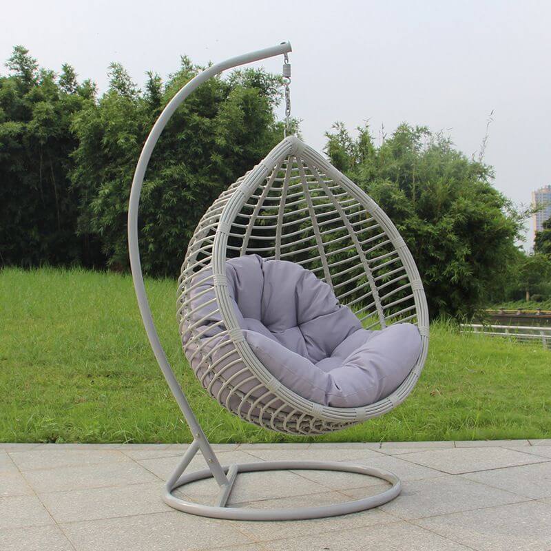 Metal porch swing with stand, cushions, and chain for comfortable outdoor seating