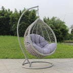 Metal porch swing with stand, cushions, and chain for comfortable outdoor seating