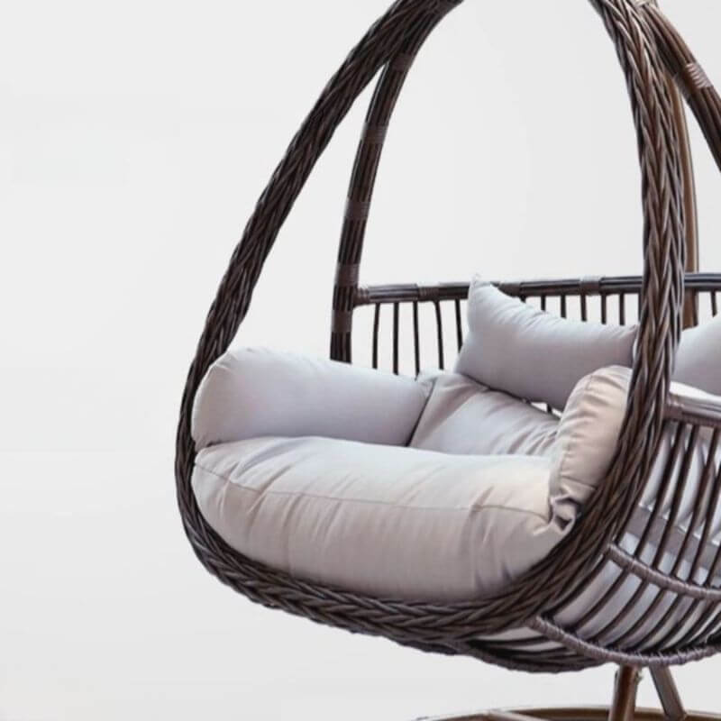 Tropical porch swing with corrosion-resistant cushions, alloy chain, and sturdy stand included