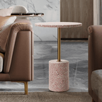 Pink terrazzo coffee table with gold accents in a modern minimalist design