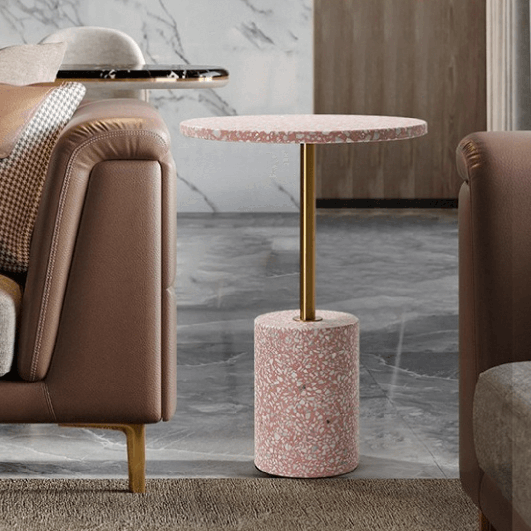 Pink terrazzo coffee table with gold accents in a modern minimalist design