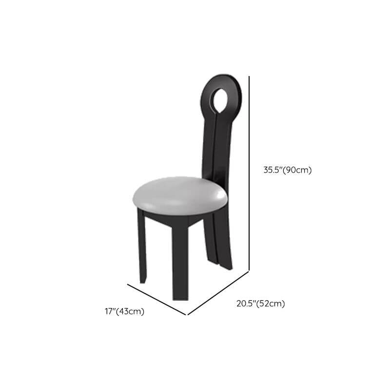 Oval marble dining table set with dual footing, solid back panel, and cushioned chairs