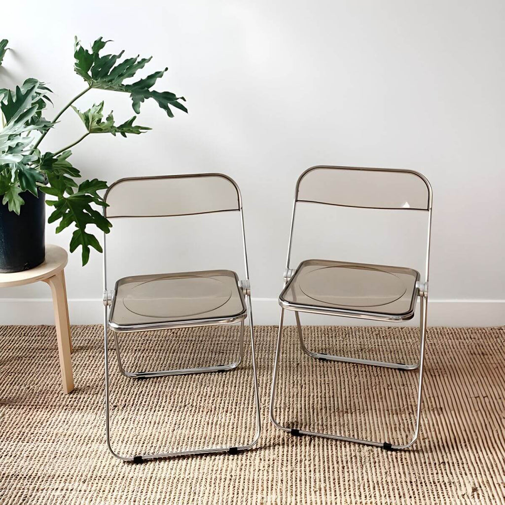 Contemporary acrylic folding armless chair with open back, ideal for dining rooms