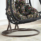 Tropical upholstered porch swing with metal chain and included stand for outdoor relaxation