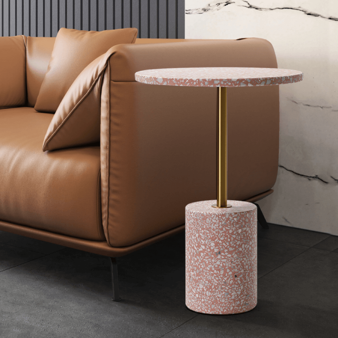 Pink terrazzo coffee table with gold accents in a modern minimalist design