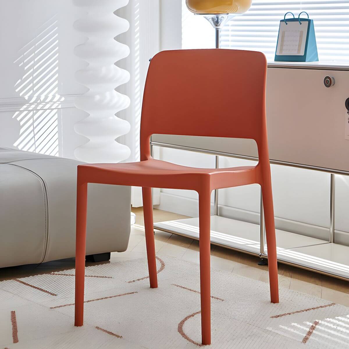 Scandinavian plastic and acrylic dining chair with low backrest and armless design