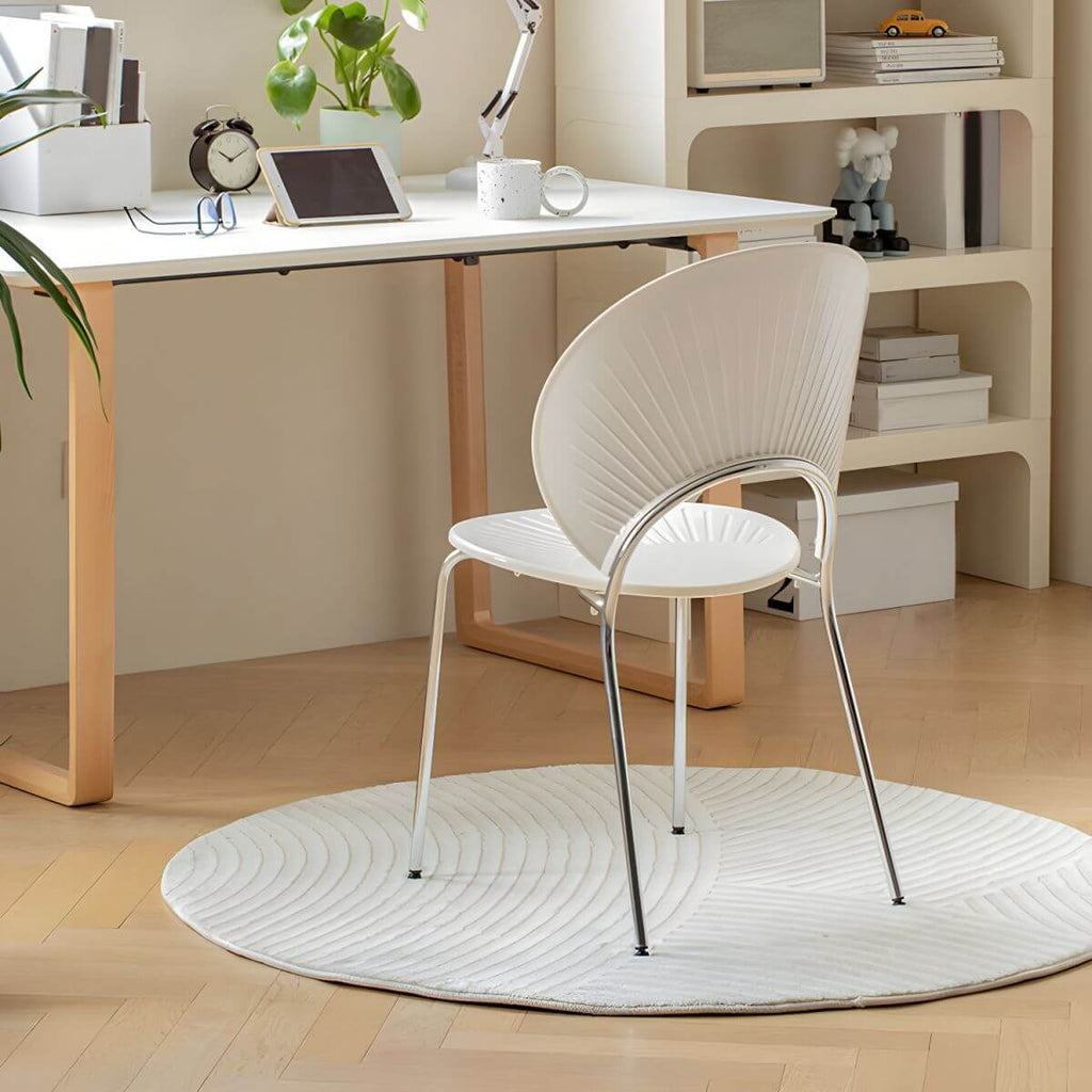 Stackable Scandinavian style dining chair with plastic seat, acrylic back, and silver legs