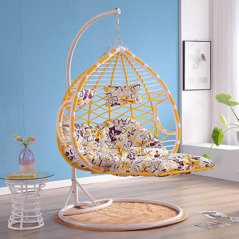 Metal porch swing with cushions, chain, and stand, designed to be heat resistant for outdoor use