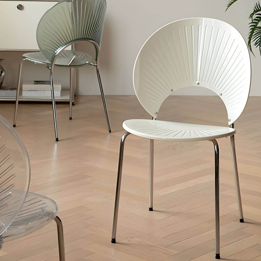 Stackable Scandinavian style dining chair with plastic seat, acrylic back, and silver legs
