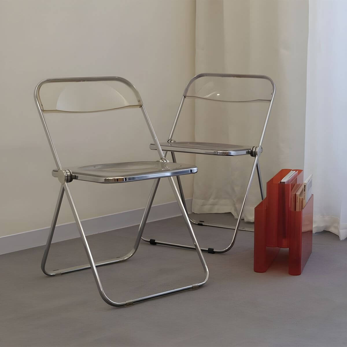 Contemporary acrylic folding armless chair with open back, ideal for dining rooms