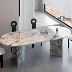 Oval dining table with white marble top and fixed base, perfect for contemporary dining rooms