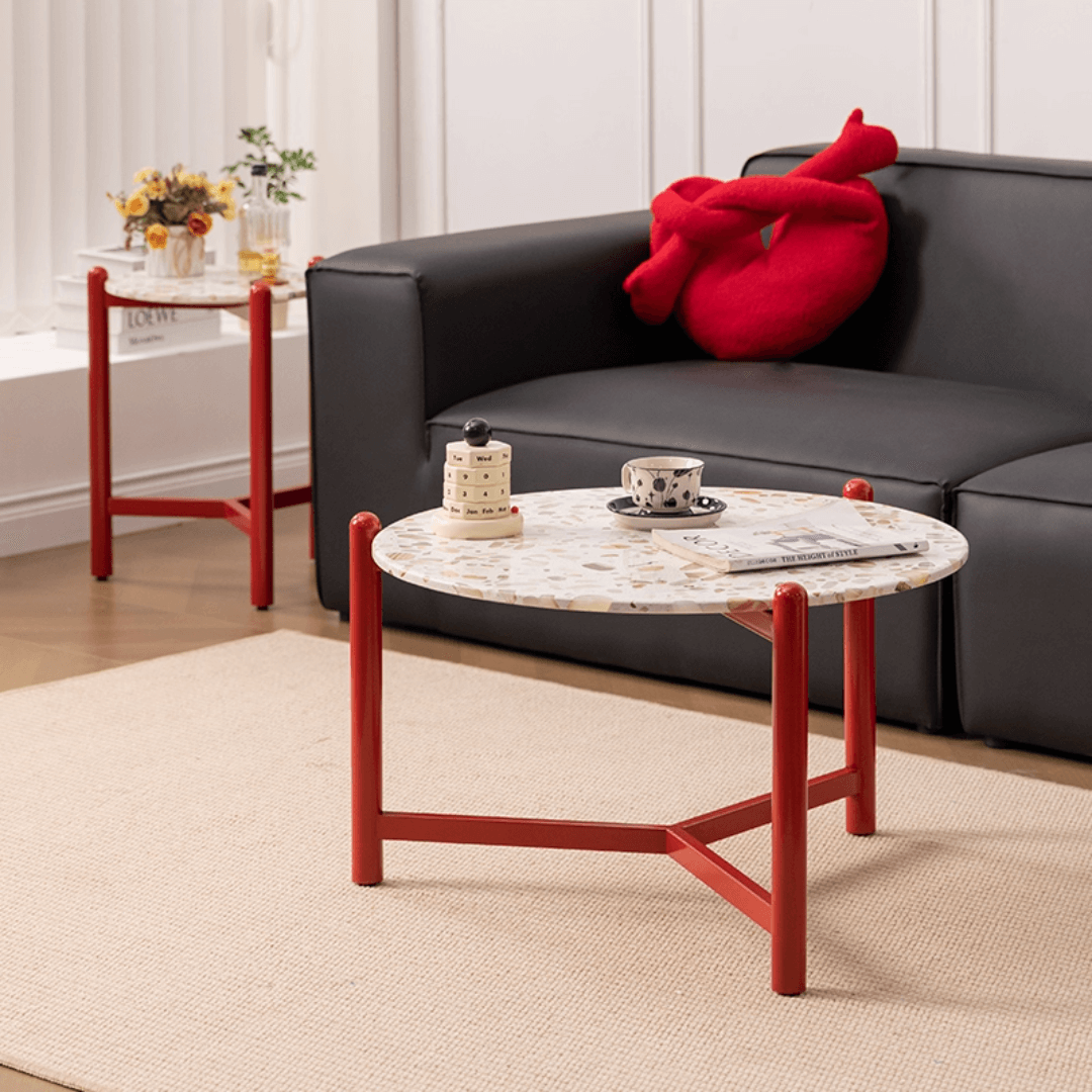 Round side table with vibrant red terrazzo top, featuring a modern minimalist design