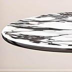 Oval marble dining table set with dual footing, solid back panel, and cushioned chairs