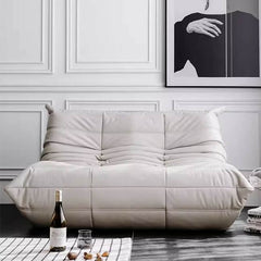 Khaki colored armless leather sofa