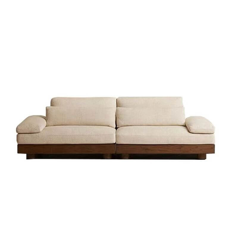 Cream Art Deco floor sofa with pillow back, pillow top arms, slipcover, and multiple pillows for seating 2 to 4 people