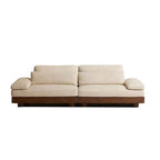 Cream Art Deco floor sofa with pillow back, pillow top arms, slipcover, and multiple pillows for seating 2 to 4 people