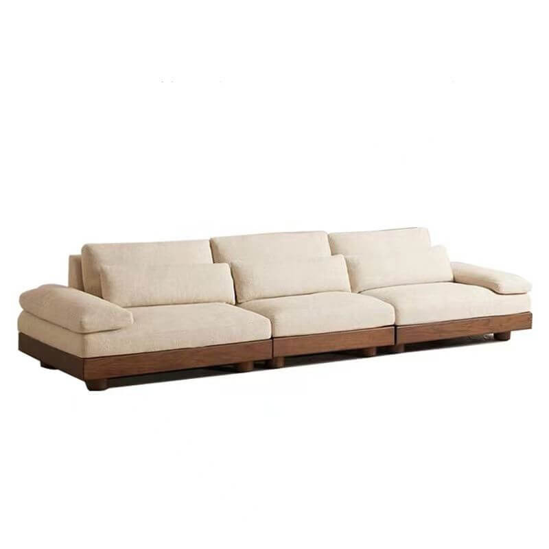 Cream Art Deco floor sofa with pillow back, pillow top arms, slipcover, and multiple pillows for seating 2 to 4 people
