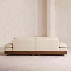 Cream Art Deco floor sofa with pillow back, pillow top arms, slipcover, and multiple pillows for seating 2 to 4 people