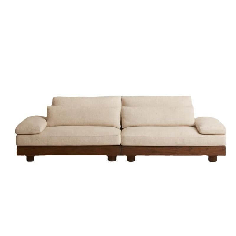 Cream Art Deco floor sofa with pillow back, pillow top arms, slipcover, and multiple pillows for seating 2 to 4 people