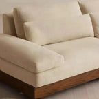 Cream Art Deco floor sofa with pillow back, pillow top arms, slipcover, and multiple pillows for seating 2 to 4 people