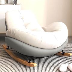 Upholstered rocking chairs arranged on wooden deck